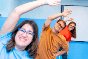 three adults exercising in a group home