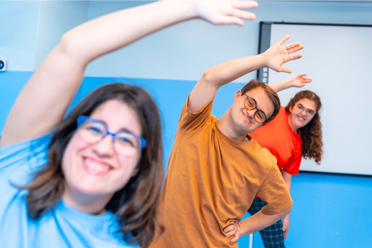 three adults exercising in a group home
