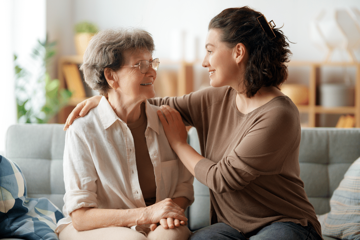 family caregiver with arm around mother