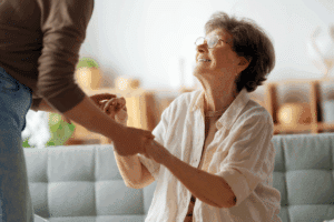 family caregiver helping mom off the couch