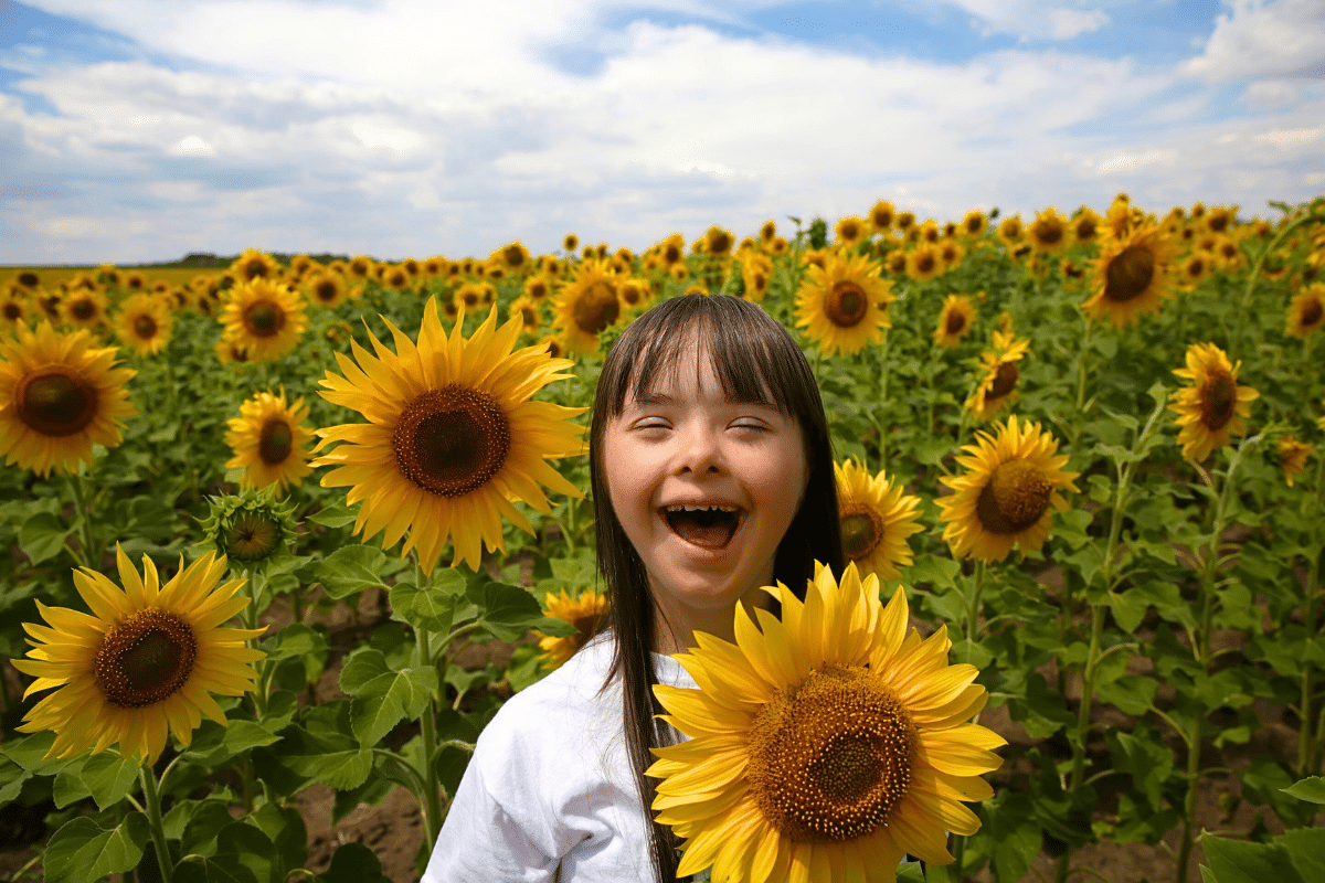 child with special needs in a sunflower field