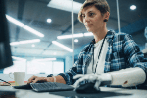 Woman with prosthetic arm working on the computer