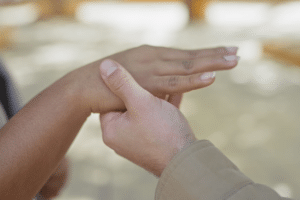 A hand holding another person's hand.