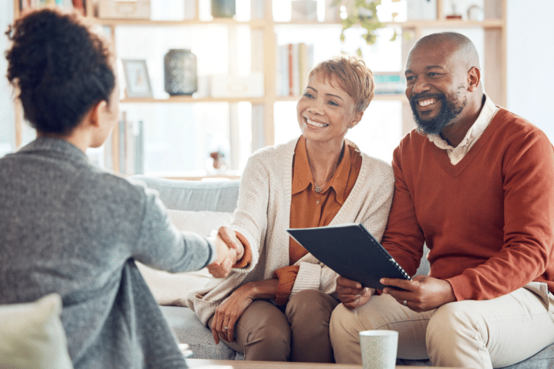 couple sitting on a couple meeting with their financial advisor