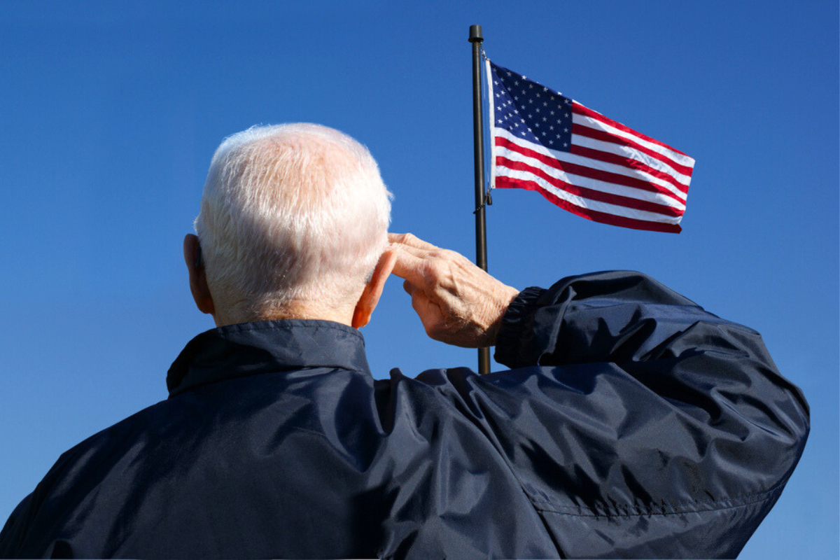 Veteran saluting the American flag