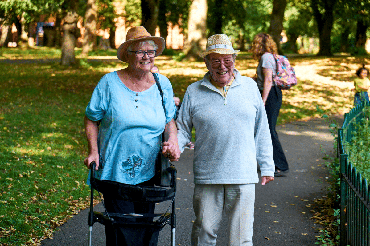 Elderly couple walking together in a park