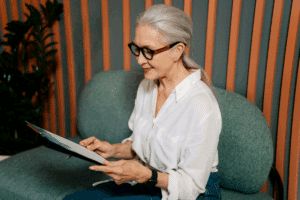 Older adult reading Medicare information on a clipboard