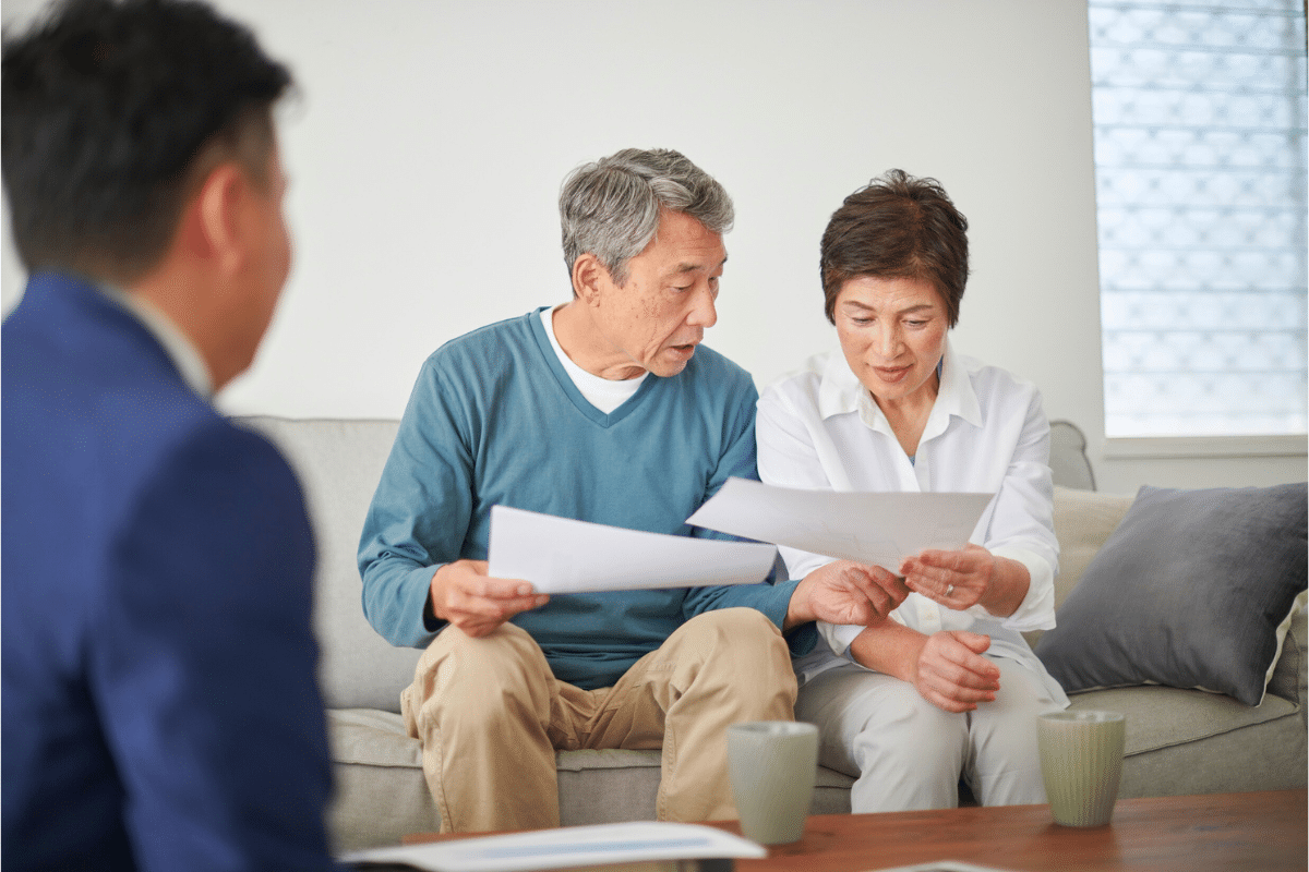 older couple reviewing paperwork on the couch