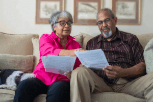 older couple reviewing documents on the couch