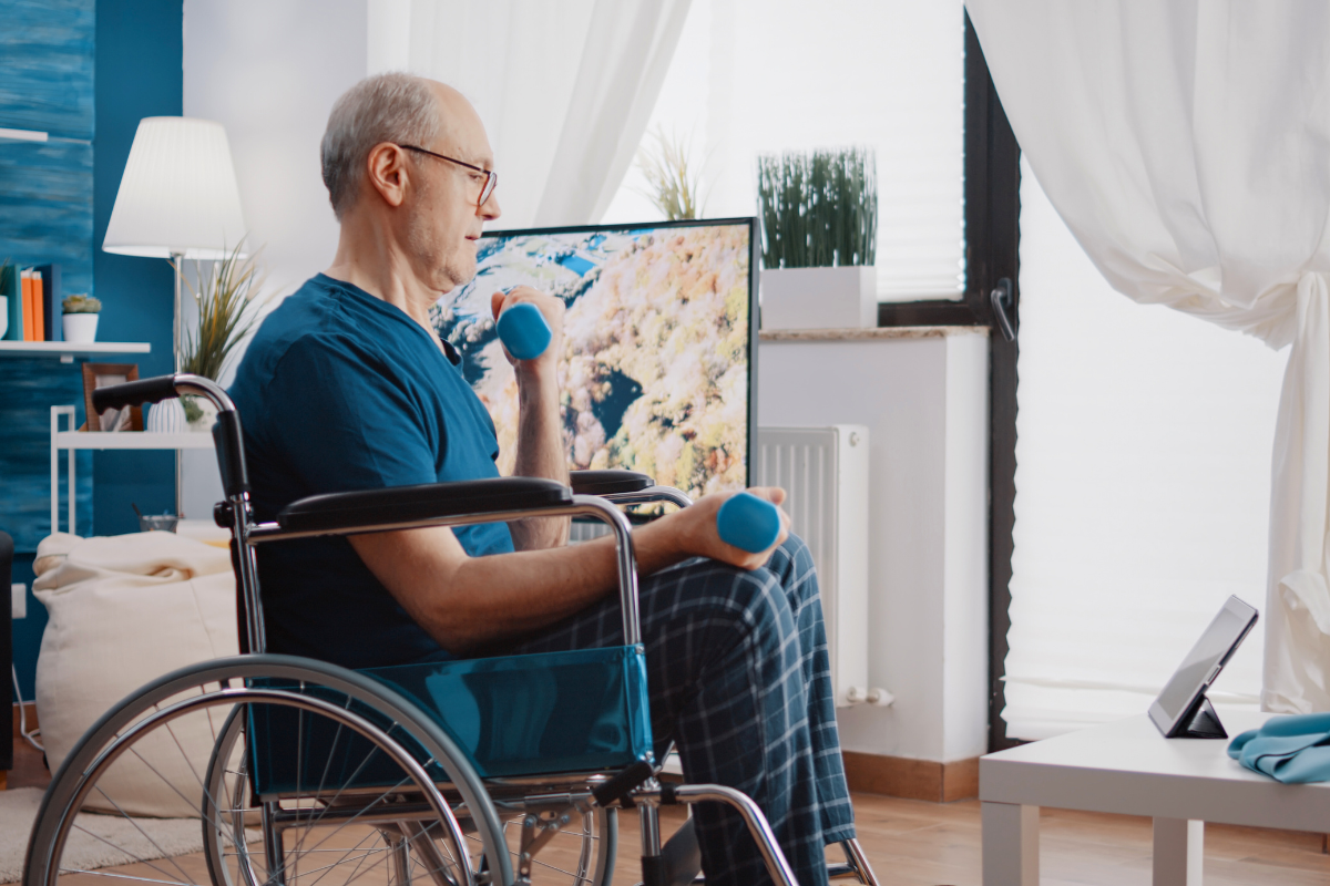 A man exercises in a wheelchair lifting weights