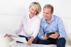 couple review estate plan and financials on the couch