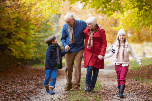 Grandparents take a walk outside with their grandchildren