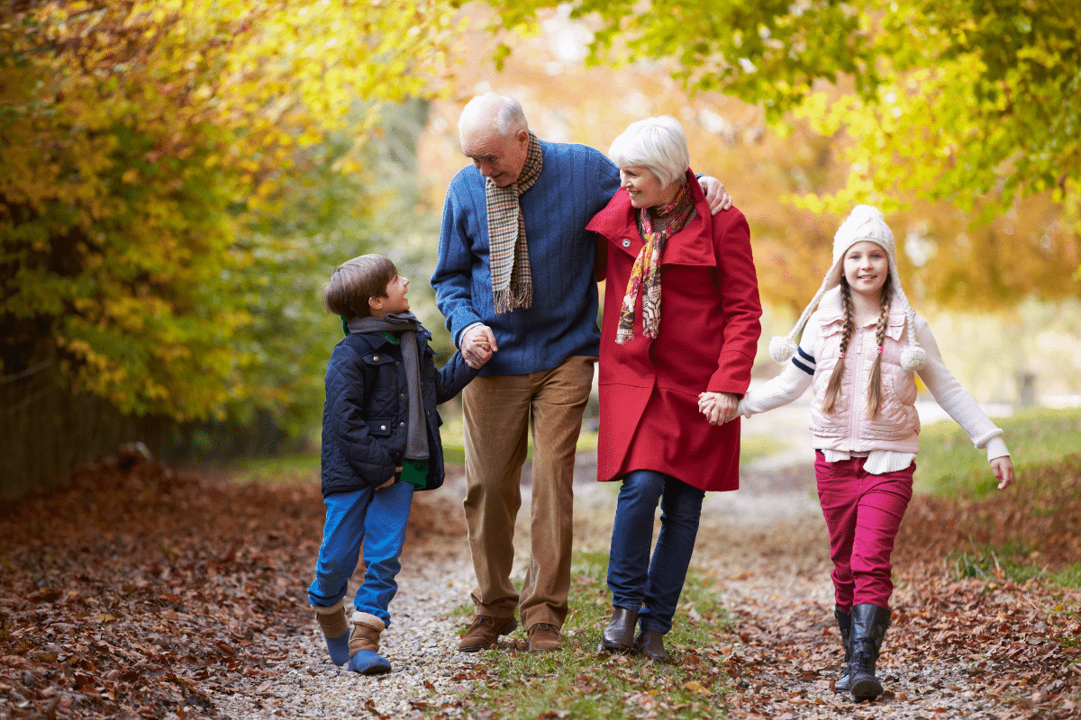 Grandparents take a walk outside with their grandchildren