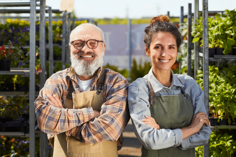 father and daughter standing together in their plant nursery